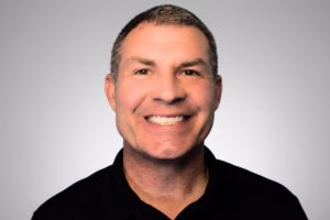 smiling man in a black shirt