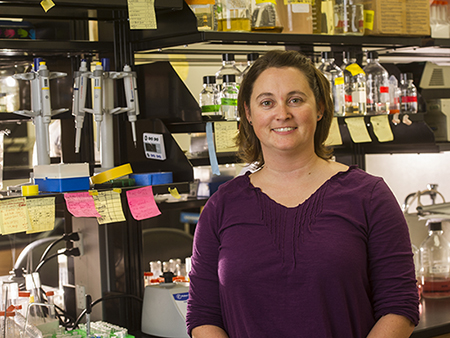 Dr. Peggy Biga standing in a lab