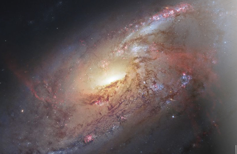 This composite image of galaxy M106 focuses on its active center, where large amounts of gas are thought to be falling into and fueling a supermassive black hole.