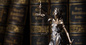 A statue of the blindfolded Lady Justice holds her scales in the air