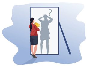 Woman looking in a mirror experiencing imposter syndrome