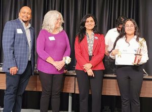 AWIS-NC Chapter President and NCSEF Volunteer Judge, Dr. Gauri Kulkarni, presenting Young STEM Star Award to Emily Martinez
