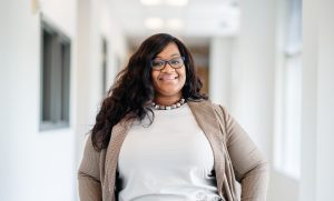 Tamara Terry wearing a suit and smiling in an office setting