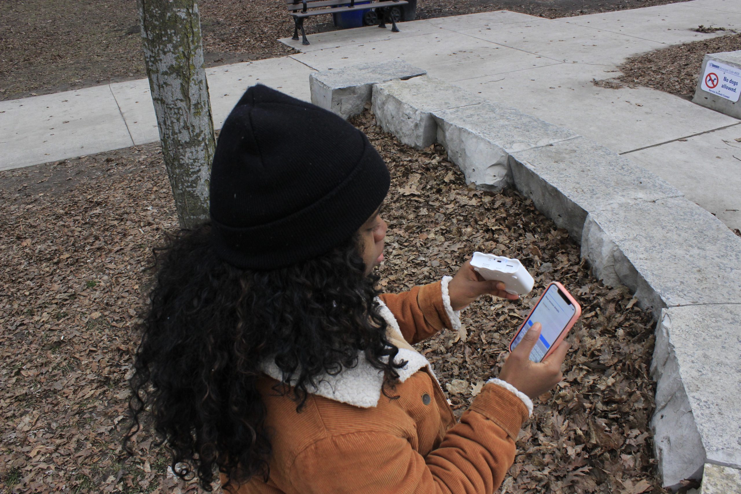 Konya using an air monitoring device in a neighborhood park. Photos taken by Christiana Ceesay